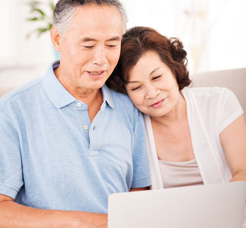 older asian couple looking at computer