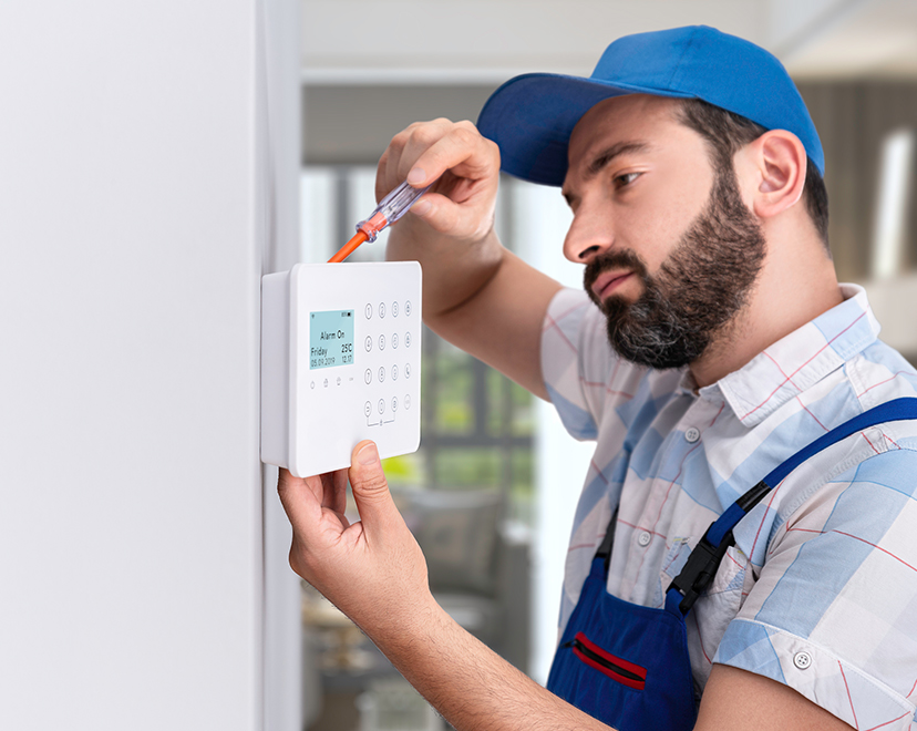 Man installing thermostat onto wall